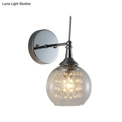 Modern chrome finish wall lamp with frosted glass globe and crystal beads for a bedroom with a modern touch