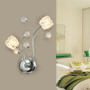 Modern chrome wall lamp with swirling arm, flower shade, three glass tulip lights, and four frosted spherical accents