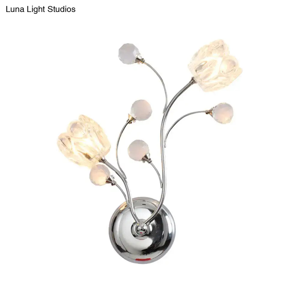 Modern chrome flower shade wall lamp with swirling arm and five illuminated glass flower shades for bedroom use
