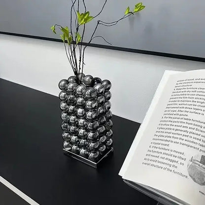 A sleek modern chrome geometric crystal ball glass vase with stacked metallic silver spheres for living room decor