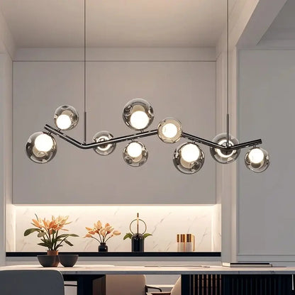 Modern chrome glass globe chandelier with multiple spherical glass globes on a branching metal frame for dining room lighting