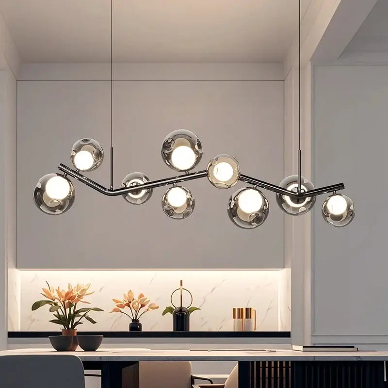 Modern chrome glass globe chandelier with multiple spherical glass globes on a branching metal frame for dining room lighting