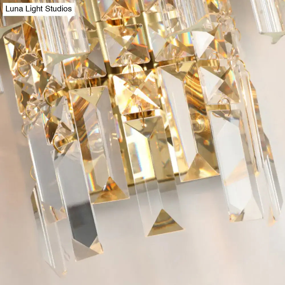 A modern chrome gold crystal prism sconce wall lamp with luxurious faceted clear crystals and gold-toned metal accents