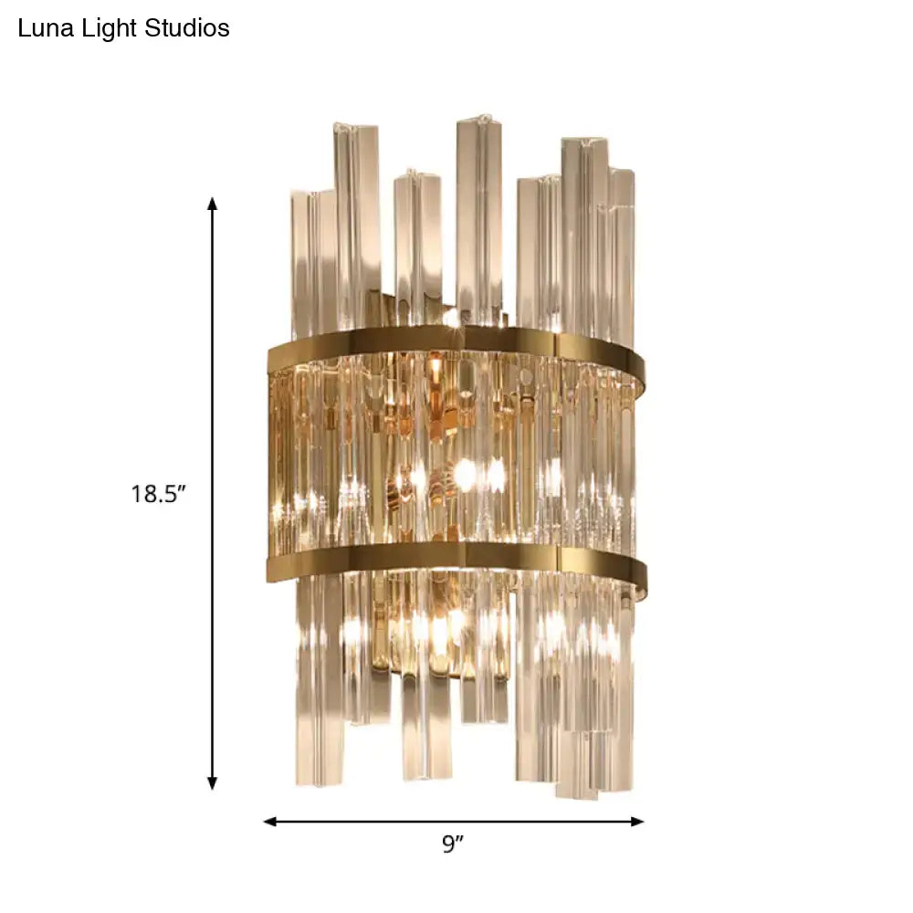 Modern chrome gold crystal prism sconce wall lamp featuring vertical crystal rods and gold-toned metal bands illuminated