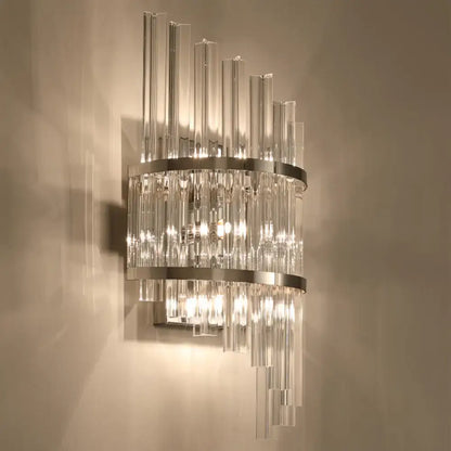 Modern wall lamp featuring clear glass rods with polished chrome and gold rings in a crystal prism sconce design