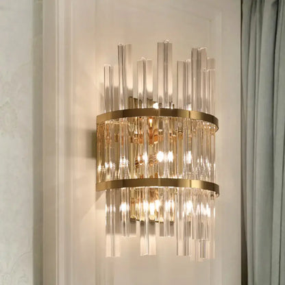 Gold-toned modern chrome gold crystal prism sconce wall lamp with vertical crystal rods and circular metallic bands for living room