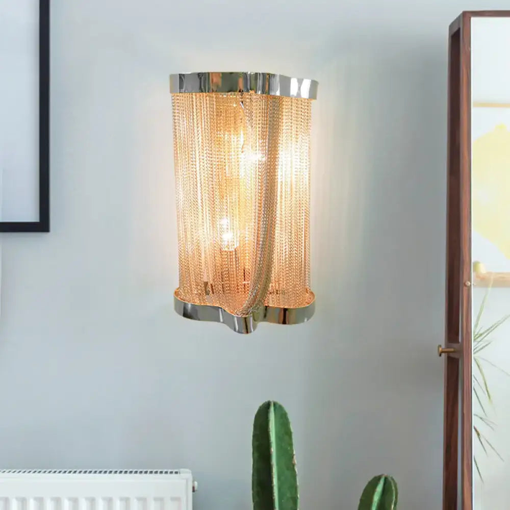 Modern chrome and gold crystal tassel wall lamp featuring a sleek cylindrical polished chrome frame and cascading chains