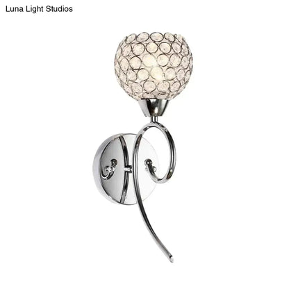 Modern chrome hemisphere crystal wall lamp featuring a spherical diffuser as a stylish bedroom sconce light