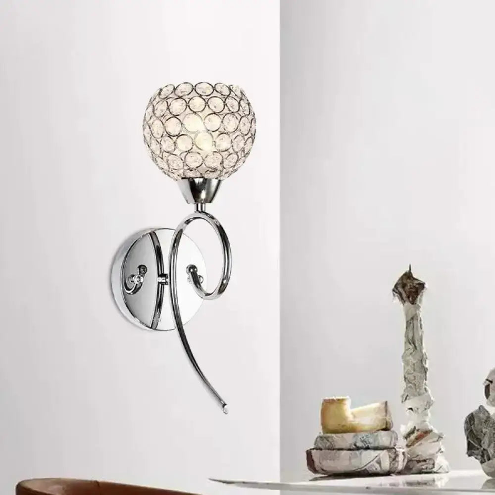Modern chrome hemisphere crystal wall lamp featuring a spherical crystal globe shade for bedroom lighting