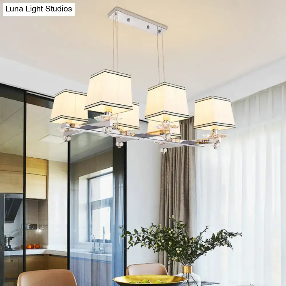 Modern chrome island pendant light with five cream fabric shades and black trim in a sleek island pendant light kit design
