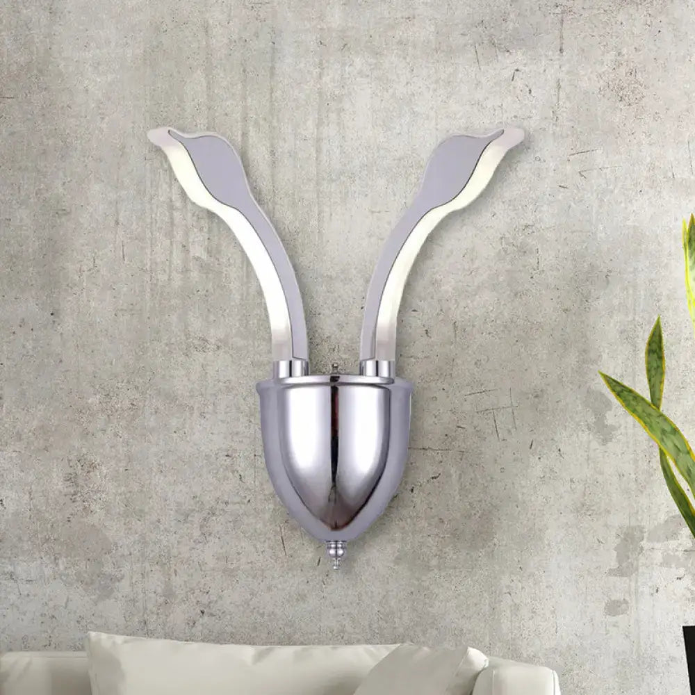 Modern chrome leaf led wall sconce with two elegant arms and acrylic shade emitting warm white light for bedroom use