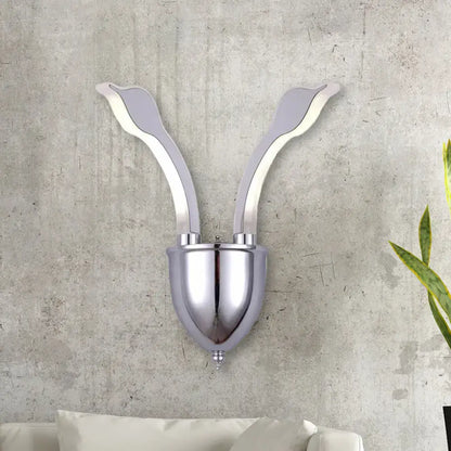Modern chrome leaf led wall sconce with two elegant arms and acrylic shade emitting warm white light for bedroom use