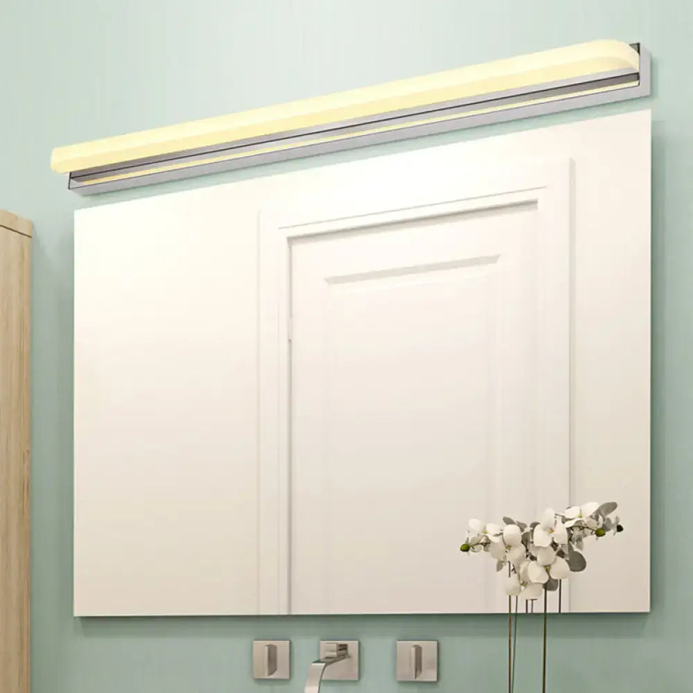 Modern chrome cylinder bar light with warm led lighting above silver-framed bathroom mirror 110v-120v