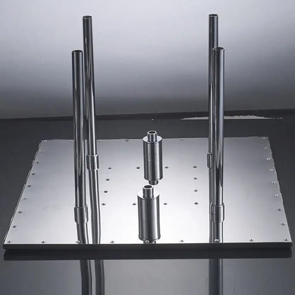 Modern chrome led rain shower head with metal stand featuring four vertical rods and cylindrical components on reflective base