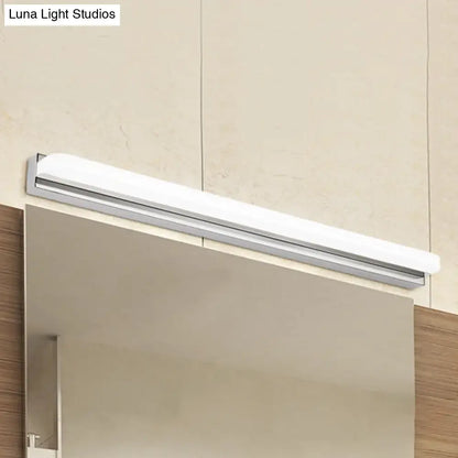 A modern chrome led wall mounted vanity light in white and silver mounted above a bathroom vanity mirror