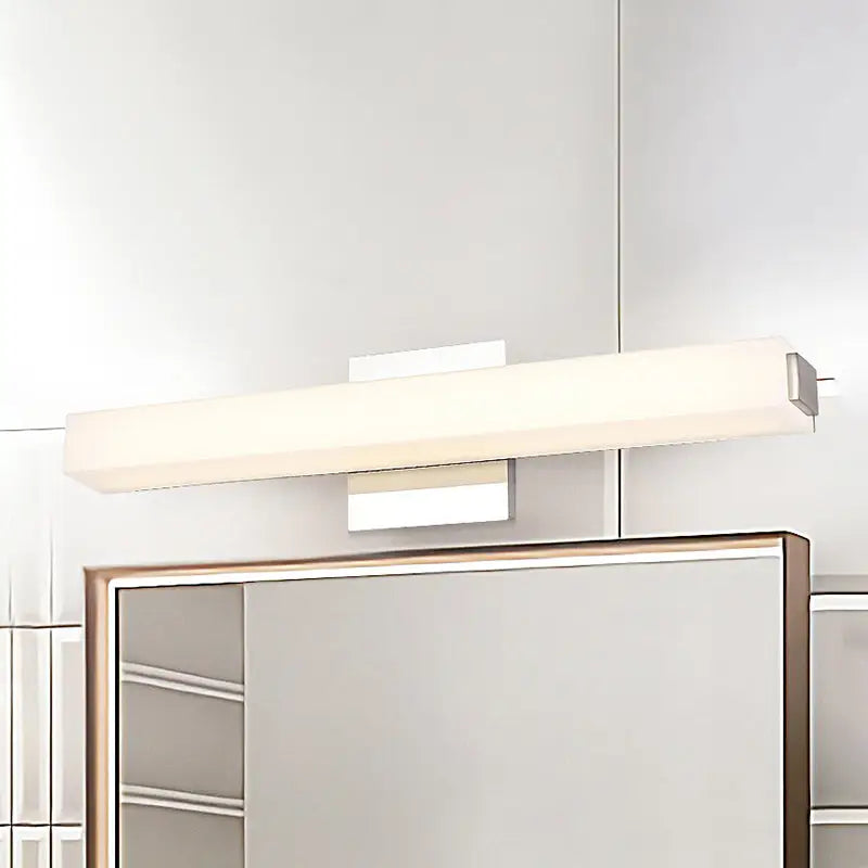 Modern chrome led wall sconce with sleek white diffuser and polished chrome finish providing warm white light for vanity use