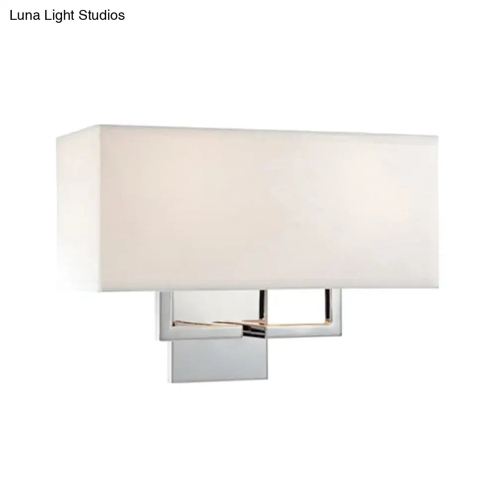 Modern chrome led wall sconce with a sleek chrome frame and soft white fabric shade for bedroom lighting