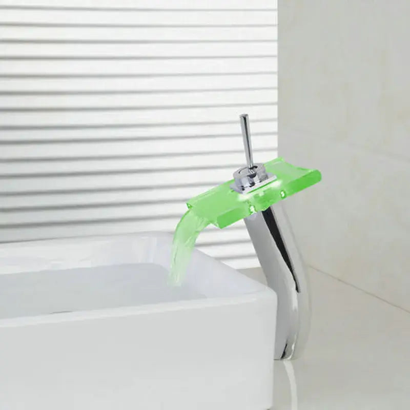A modern chrome led waterfall glass basin mixer faucet with a translucent lime green acrylic spout by decorbites led waterfall