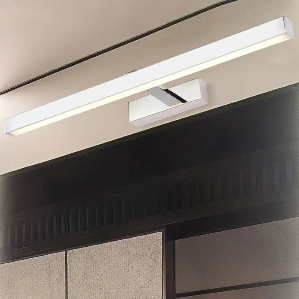 Modern chrome led white rod wall lamp wall light with sleek minimalist design mounted above dark bathroom vanity cabinet