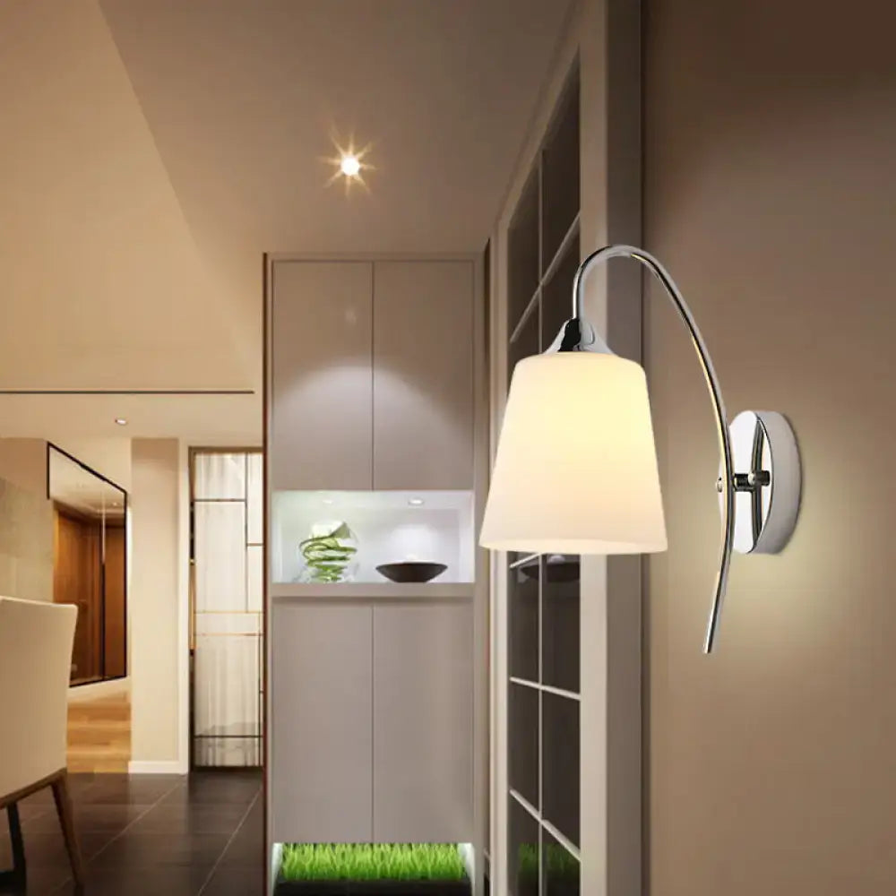 Modern chrome wall sconce with milky glass fabric shade designed as a trumpet shape for stairway lighting