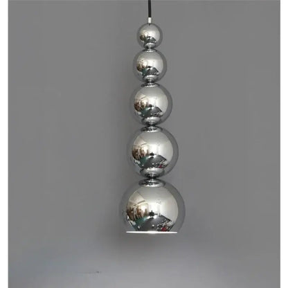A modern chrome multi ball pendant light with five reflective spherical bulbs as a stylish light source