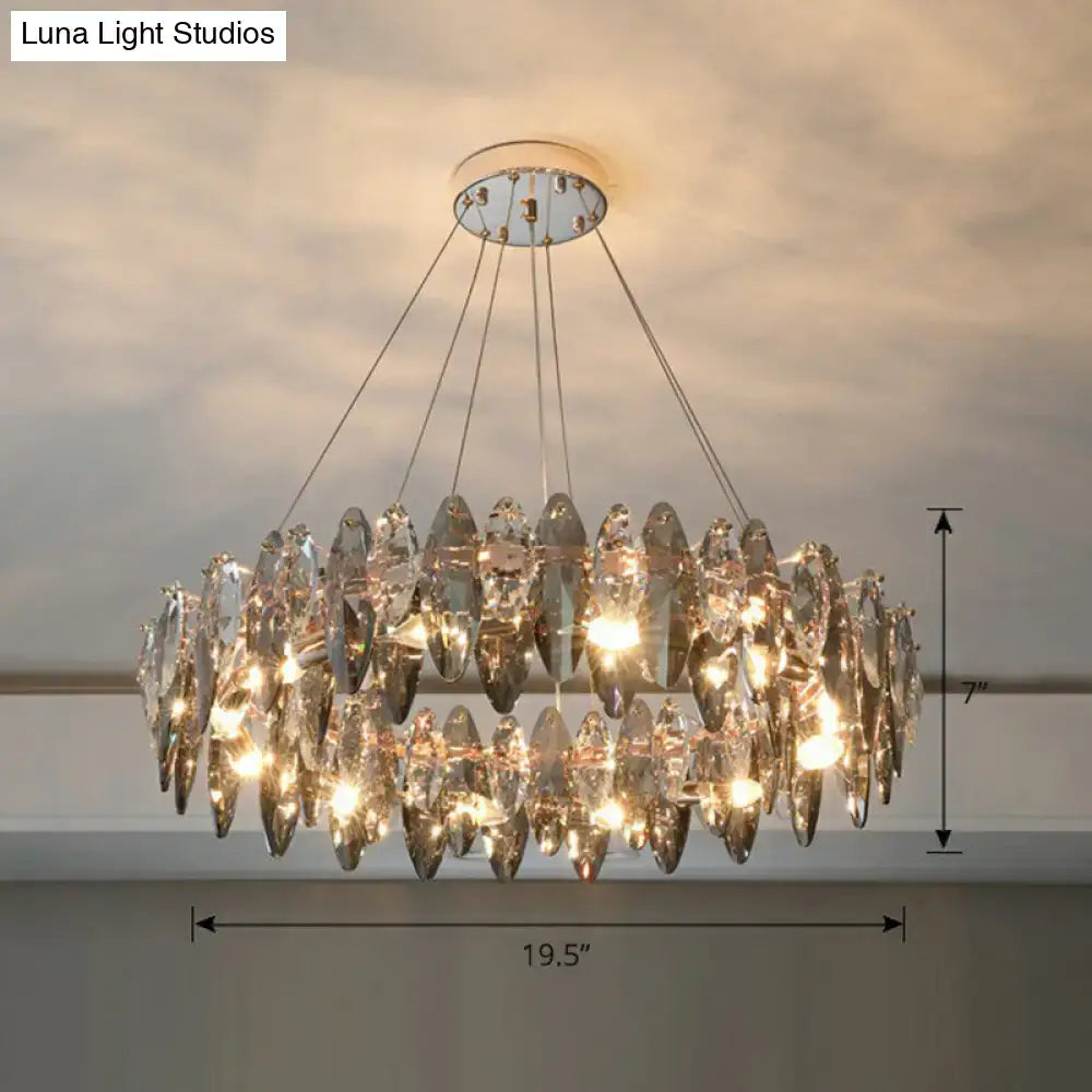 A two-tiered minimalist oval crystal clear pendant chandelier with faceted teardrop glass on chrome 220v-240v ceiling mount