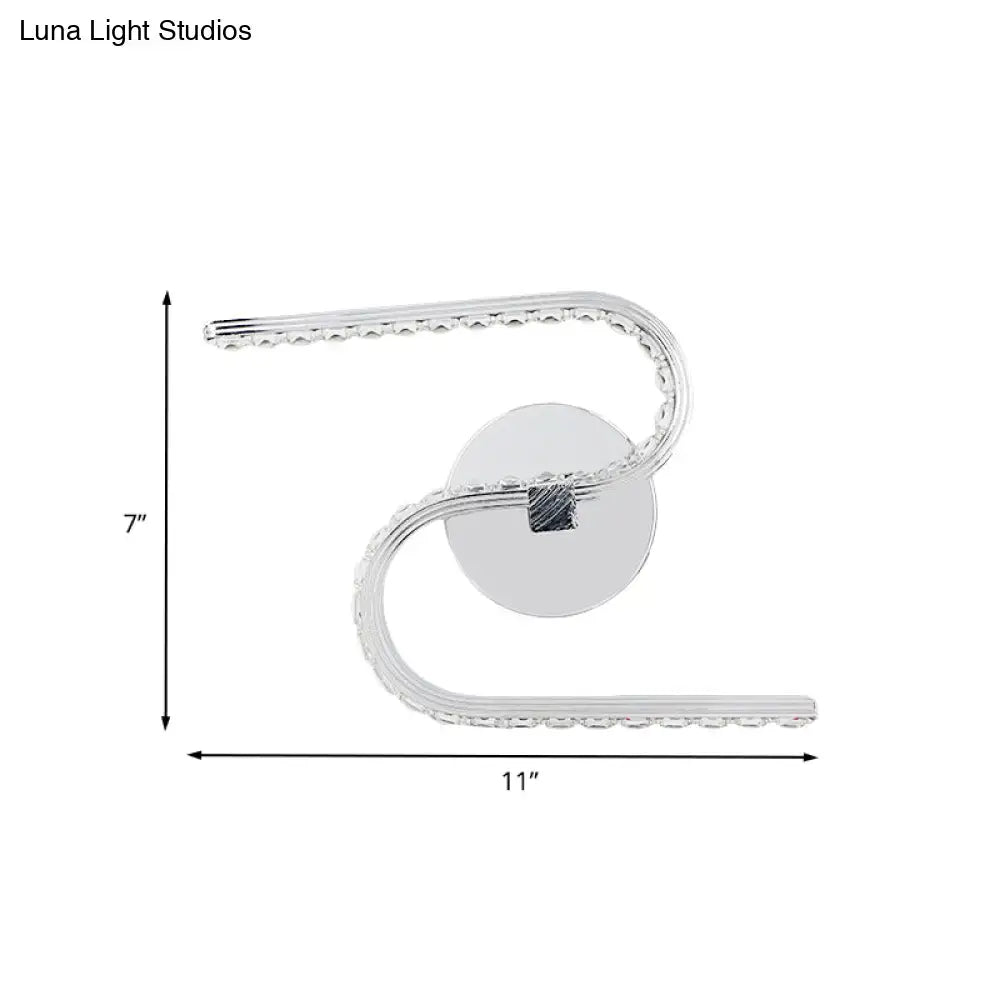 Silver modern s-shape led wall sconce with acrylic shade, curved design, embedded crystals, and warm white light