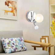 Modern chrome sconce with dual globe glass shades featuring a chrome finish for elegant living room lighting