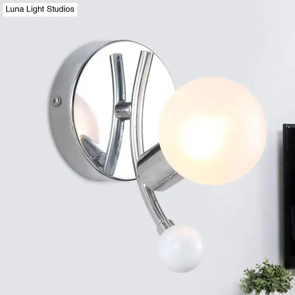 Modern chrome sconce featuring dual frosted and white globe glass shades for living room wall lighting