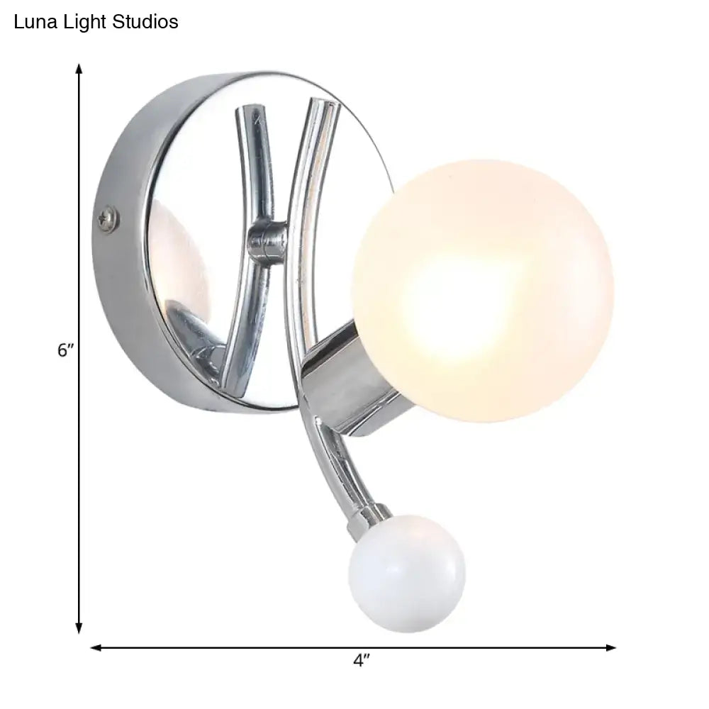 Modern chrome sconce with dual globe glass shades featuring one warm glowing and one opaque white sphere for living room