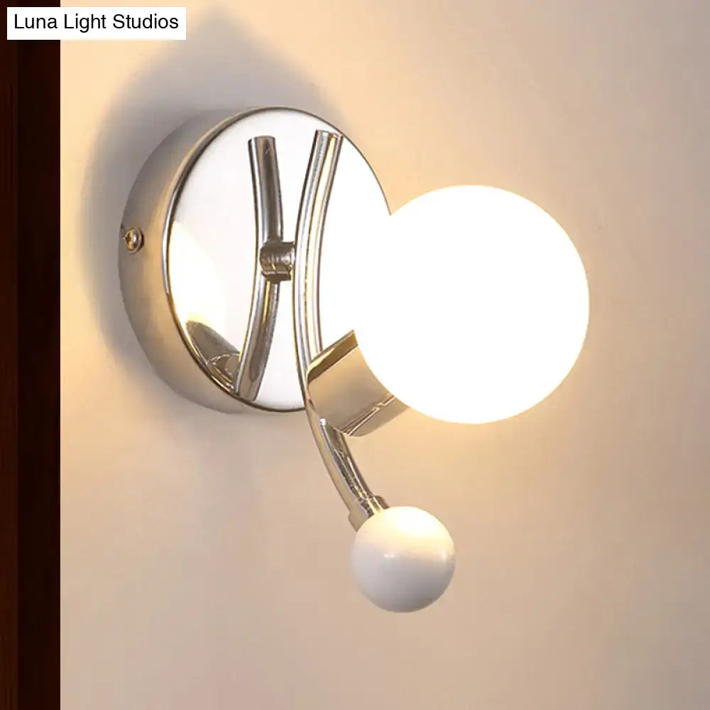 Modern chrome sconce with dual globe glass shades featuring a sleek curved arm and glowing white bulbs for living room