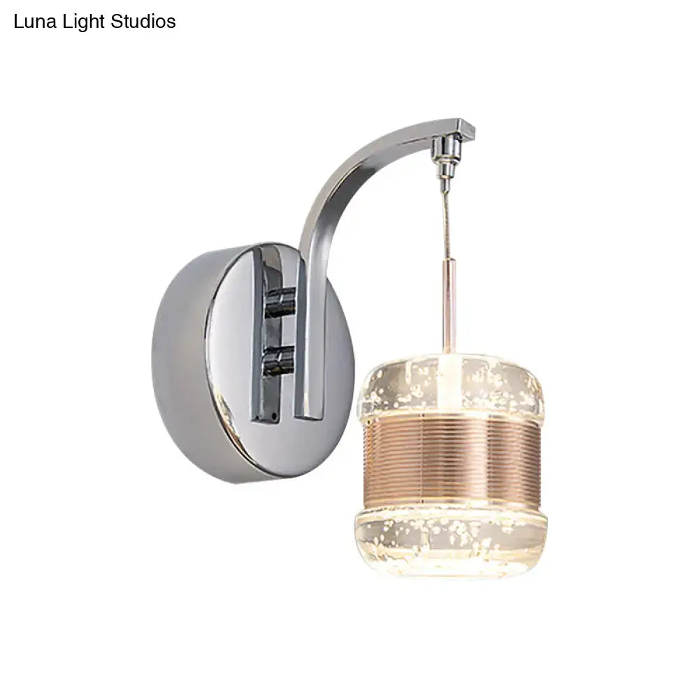 Modern chrome wall lamp with curved arm and seeded crystal chrome cylinder glass shade with copper-toned ridges