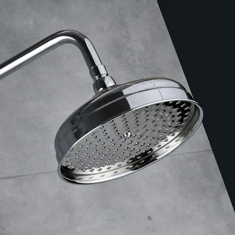 Modern chrome shower mixer faucet set with round chrome-finished showerhead and evenly spaced perforations for water distribution