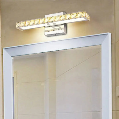 Modern silver champagne linear wall sconce with sleek chrome finish and crystal accents emitting warm white light