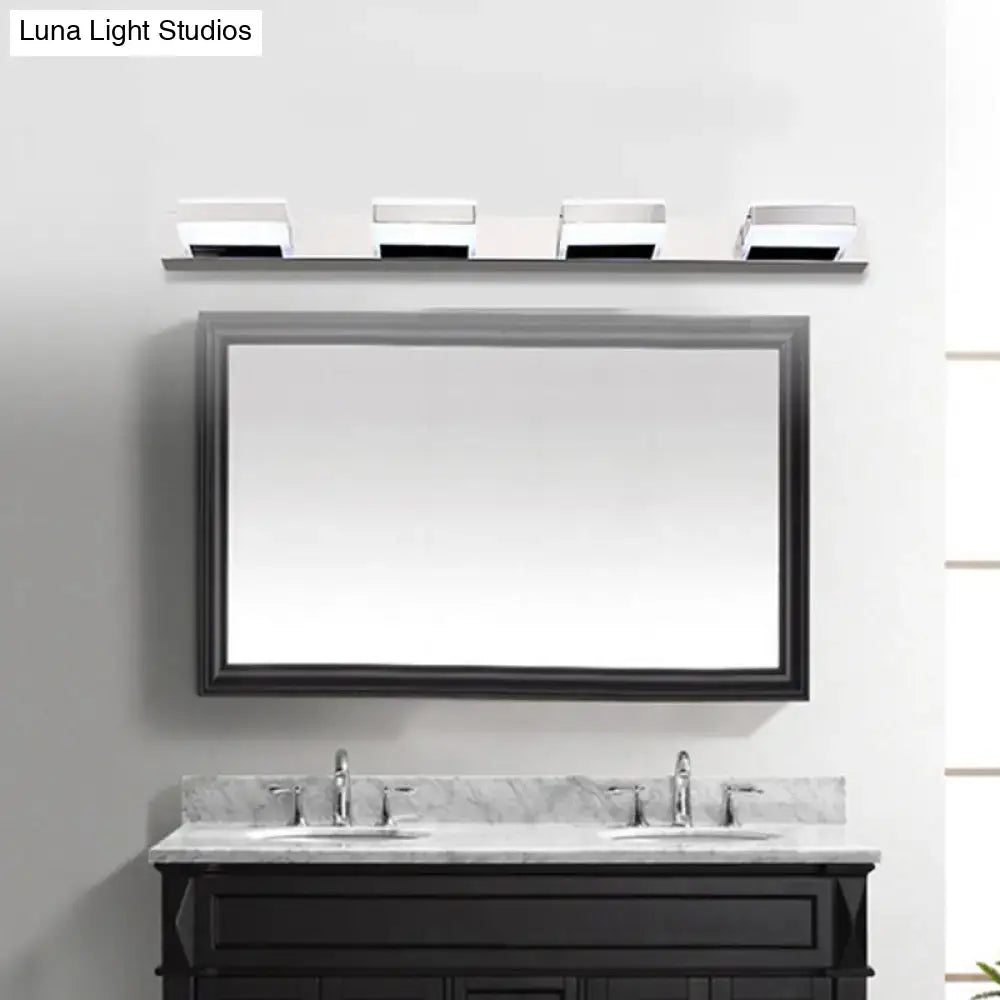 Modern chrome square acrylic vanity light fixture height above black-framed rectangular bathroom mirror and double-sink vanity
