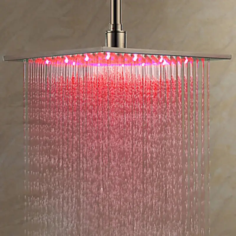 Modern chrome square rainfall shower head with brushed nickel finish and integrated red led lights for bathroom use
