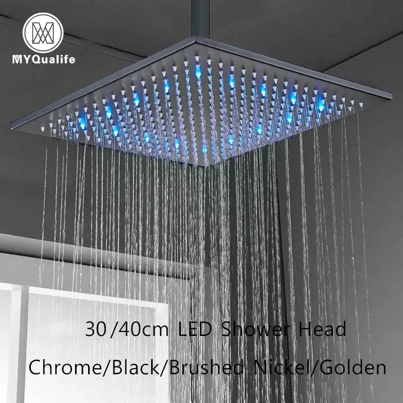 Modern chrome square rainfall shower head with led lights and blue illuminated spray nozzles for bathroom use