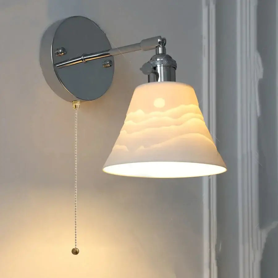 Modern chrome sunrise iron ceramic led wall lights feature a warm-toned ceramic lampshade on a sleek chrome fixture