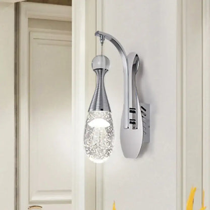 Modern chrome teardrop led sconce with chrome metal arm and base featuring seeded crystal glass pendant for bedroom use