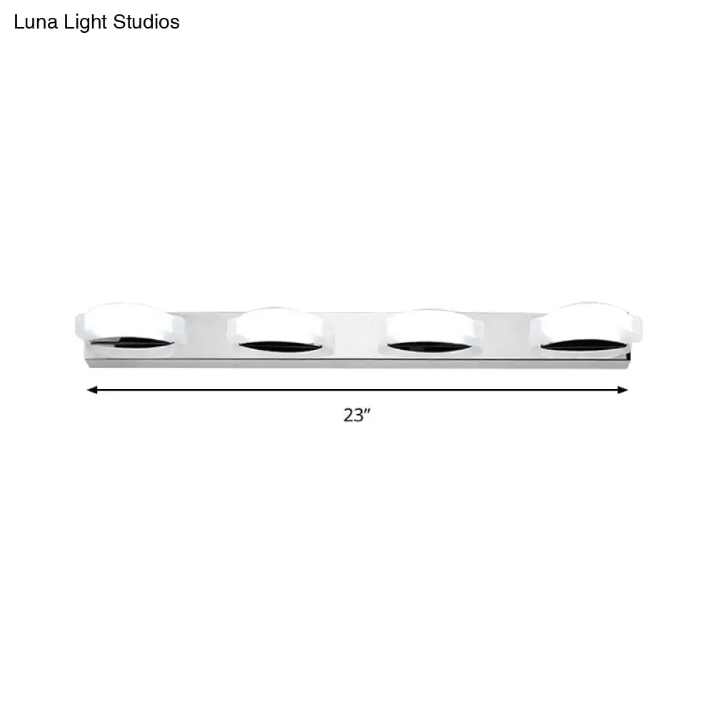Modern chrome vanity mirror light fixture with four white warm color circular diffusers and warm color temperature