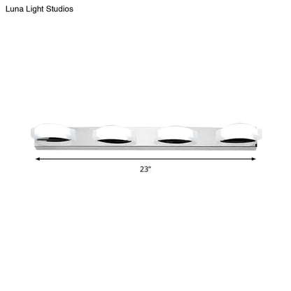 Modern chrome vanity mirror light fixture with four white warm color circular diffusers and warm color temperature