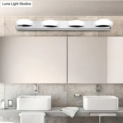 Modern chrome vanity mirror light with three circular white warm color diffusers and warm color temperature