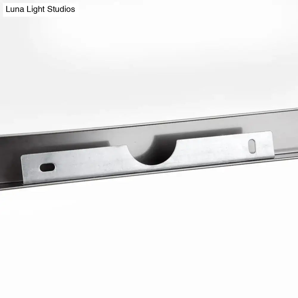 Silver metallic mounting bracket with central cutout for secure attachment on modern chrome vanity mirror light with warm color temperature
