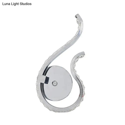 Modern chrome twist led wall light with curved scalloped edge design emitting warm white light for bedroom use
