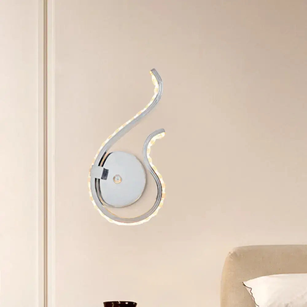 Modern chrome twist wall light with sleek curved design and integrated warm white light for bedroom illumination