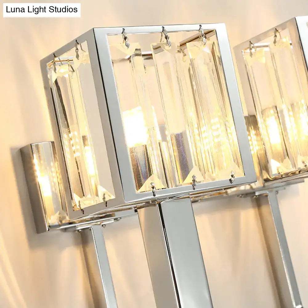 Modern chrome wall lamp with clear crystal rectangular prisms and metal frames for living room illumination