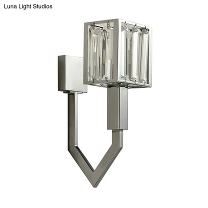 Modern chrome wall lamp with clear crystal encased rectangular light and geometric metal frames for living room use