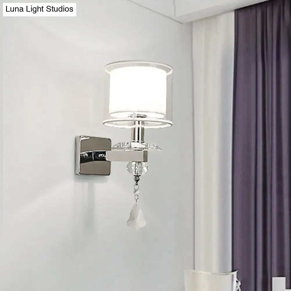 Modern chrome wall lamp with double glass cylinder shade and crystal accent for elegant bedroom lighting