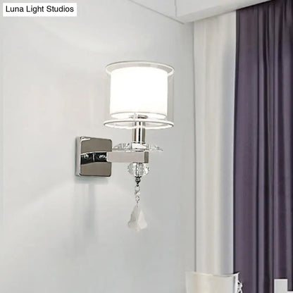 Modern chrome wall lamp with double glass cylinder shade and crystal accent for elegant bedroom lighting