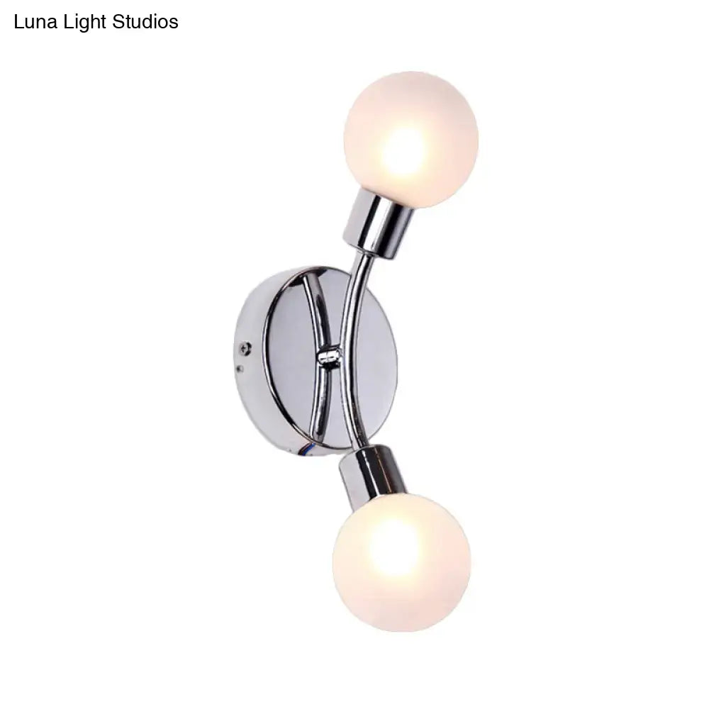 Modern chrome wall lamp with two frosted glass fixture bulbs mounted on a chrome bulb base for bedroom use